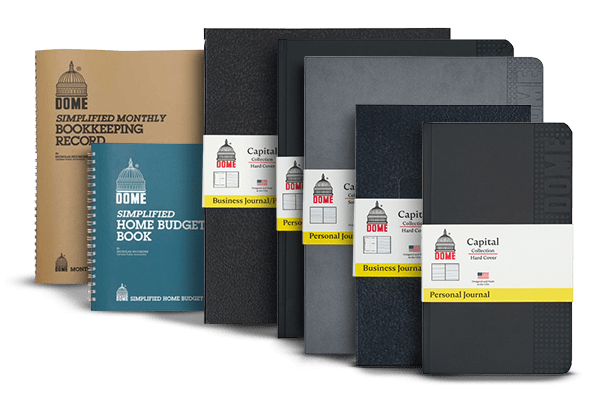 A variety of Dome-brand financial record books and journals, including bookkeeping, home budget, business journals, and personal journals, displayed upright in a row against a white background.